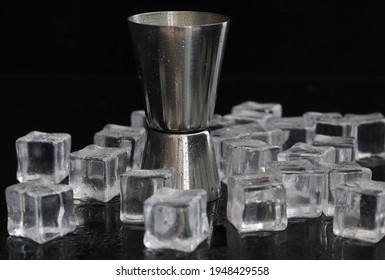 Metal jigger for mixing coctails with ice cubes.