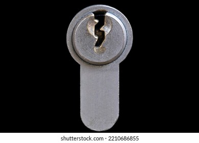 Metal Key Plate With Keyhole Of A Cylinder Lock In A Door. Isolated On Black Background