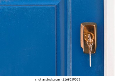 Metal Keys In Golden Lock Fro. Blue Door