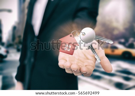 Metal keys with red home ring against new york street