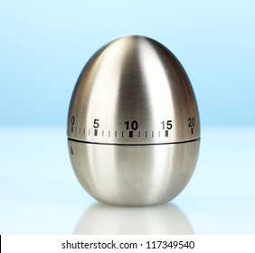 Metal Kitchen Egg Timer On A Blue Background