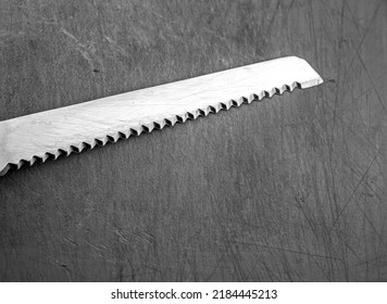 The Metal Knife Blade With Grunge Teeth. Steel Knife Old. Rigid Black Knife, Harsh Kitchen Concept.