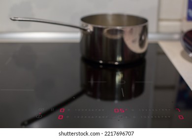 Metal Ladle On The Turned On Cooking Panel