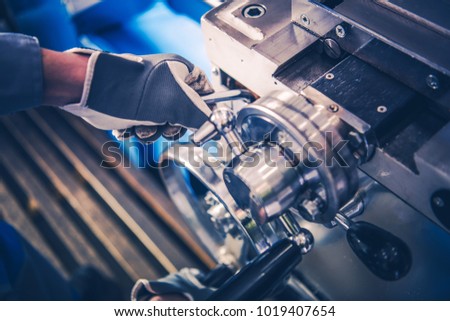 Metal Lathe Machine Operator Closeup Photo. Lathe Adjustment and Calibration.