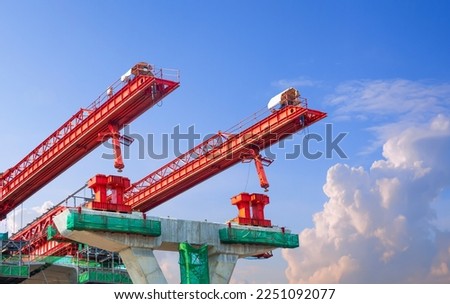 Metal launching gantry Structure for installing concrete typical Segment Joint on foundation of Elevated Expressway in road Construction site against blue sky background
