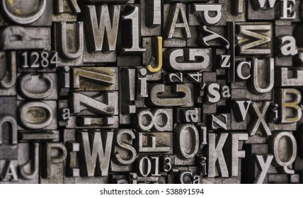 Metal Letterpress Types. 
Historical letterpress types, also called as lead letters. These kind of letters were used in Gutenberg presses. These letters were the beginning of typography - Shutterstock ID 538891594