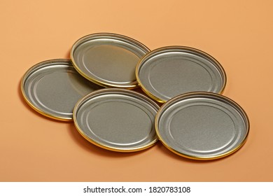 Metal Lids For Canning Lie With The Back Side Out On An Orange Background Close Up