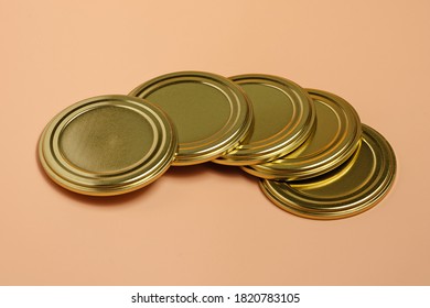 Metal Lids For Canning Lie On An Orange Background Close-up