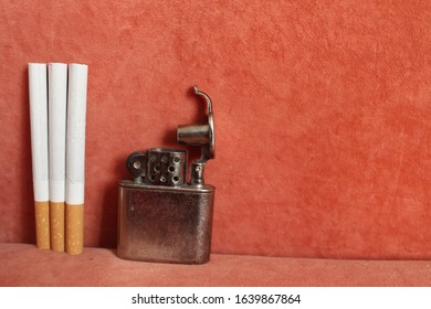 Metal Lighter And 3 Cigarettes Shift Left Red Background