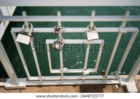 the metal locks on the fence above the sea
