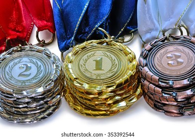 Metal Medals For The First Second And Third Place With Ribbons Of Red Blue And White Colours Lies A Pile One On Another Isolated On White Background