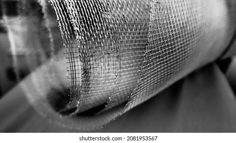 Metal mesh. Rolled mesh in gray. Heavy duty steel or aluminum mesh with ragged edges