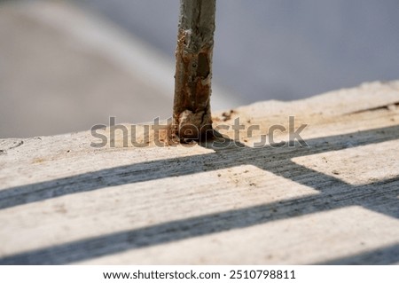 Metal net window fence shadow on horizontal concrete wall surface background.