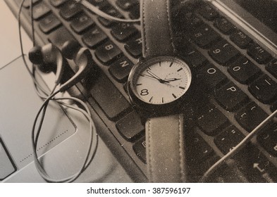 metal notebook  and clock and headphones background