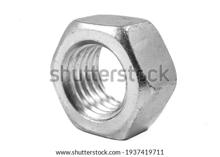 Metal nut with metric thread. Metal accessories for assembling metal parts. Light background.
