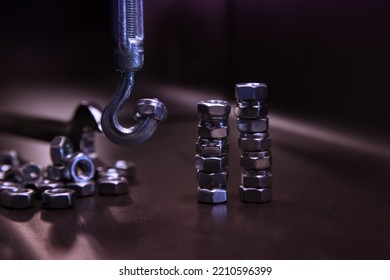 Metal Nuts, Construction Hook On A Dark Background