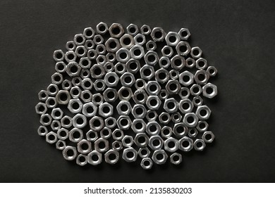 Metal Nuts On Dark Background. Chromed Screw Nuts Isolated. Steel Nuts Pattern. Set Of Nuts And Bolts. Tools For Work. Black And White