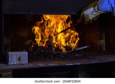 The Metal Object Inside The Flaming Blaze Is Currently Unrecognizable. It Will Soon Be Crafted Into A Unique One Of A Kind Hand Forged Knife. Bokeh.