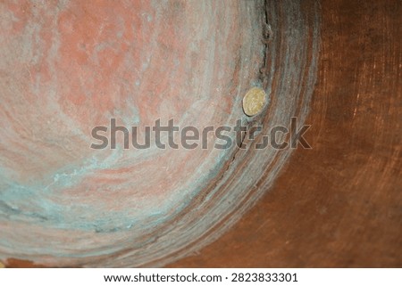 Metal Patch. Concave Handcrafted Copper Surface. Rings of Patina. Wear and Natural Oxidation. Shallow Depth of Field. Copy Space.