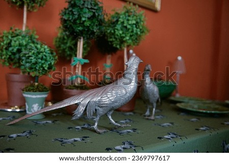 metal pheasant, bird in a cage, close up of a bird, silver bird, portuguese silver, interior decoration, decorative birds, bird sculpture, blurred background, country decor, vintage decor
