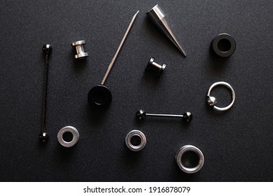 metal piercing on dark gray background closeup.