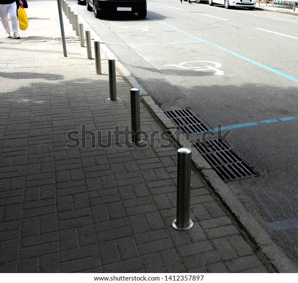 
metal pillars, against cars on the footpath for
people.