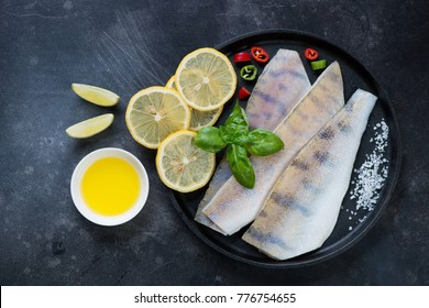 Metal plate with raw fresh sudak fillet and seasonings on a dark scratched metal background, flat-lay - Shutterstock ID 776754655
