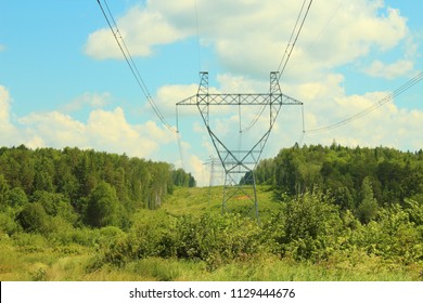 Metal Poles Of Power Lines. High-voltage Direct Current Line. Power Transmission Towers. Close-up On Nature.