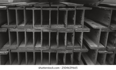 Metal profile beam in packs at the warehouse of metal products.Wi-Frank Steel,Flange beam in warehouse,steel beams placed outside on a steel rack,steelwork,Steel skeleton at a construction site - Powered by Shutterstock