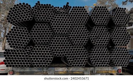 Metal profile pipes of rectangular cross section in packs at the metal products warehouse. square steel pipe for construction equipment Warehouse of pipes and pipes in a metal shed