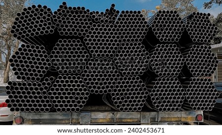 Metal profile pipes of rectangular cross section in packs at the metal products warehouse. square steel pipe for construction equipment Warehouse of pipes and pipes in a metal shed