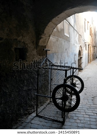 Metal pushcart in empty alleyway in the evening, Essaouira, Morocco. High quality photo