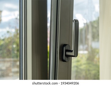 Metal Or PVC Window Vertical Open Closeup View. Tilt And Turn Grey Color Aluminum Window, Fresh Air For Home. Energy Efficient, Security Profile Metal Door Frame.