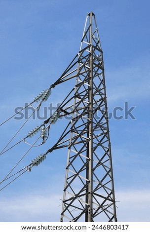 metal pylon with high voltage cables for the transport of electricity from the electrical substation to the users