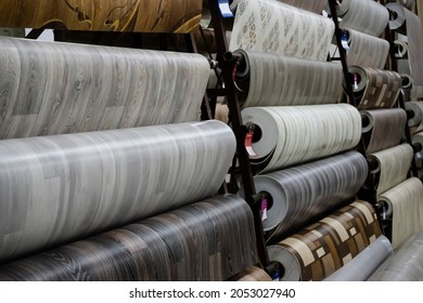 Metal Rack With Samples Of Assortment Of Floor Coverings Linoleum Isolated On White Background. Shelving In Repair Materials Store And Interior.