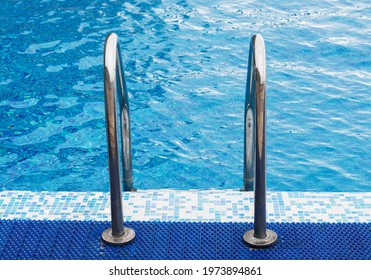 Metal Railing In The Pool For Safety When Descending Into The Water.Handrails For People In The Public Pool.