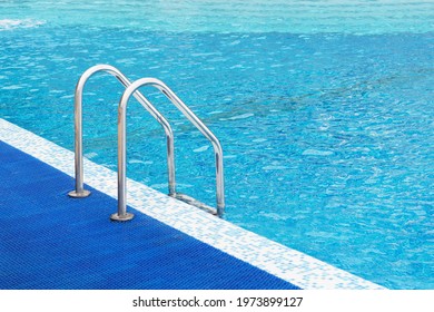 Metal Railing In The Pool For Safety When Descending Into The Water.Handrails For People In The Public Pool.