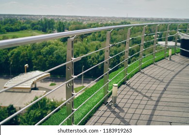 Metal railings. Grass. 