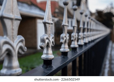 Metal railings topped with silver finials - Shutterstock ID 2266502549