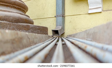 Metal Rain Drain At The Base Of The Building.Very Soft Focus