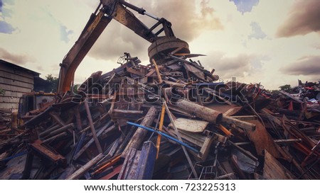 Metal recycle factory, Backhoe use electromagnets crane keeping metal. Vintage filter effect. Environment and save the world concept.