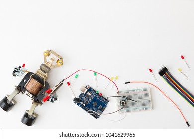 A metal robot and an electronic board that can be programmed. Robotics and electronics. Laboratory in the school. Mathematics, engineering, science, technology, computer code. STEM education for kid. 