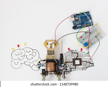 A Metal Robot And An Electronic Board That Can Be Programmed. Robotics And Electronics. Laboratory In The School. Mathematics, Engineering, Science, Technology, Computer Code. STEM Education For Kid. 