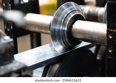 A metal roller designed to shape metal into a V-shape, showcasing the precision and mechanical detail of the roller as it forms metal profiles in industrial applications.