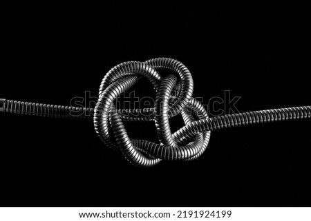 metal rope knot isolated on black background