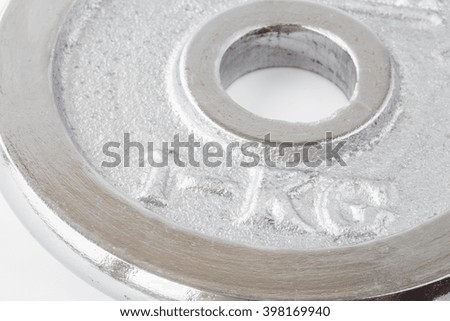 Metal round weight of one kg closeup in silver
