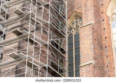 Metal scaffolding near a gothic cathedral, church, old antique buildings renovation and restoration works in the city simple concept, landmarks, cultural heritage care and protection, nobody no people - Shutterstock ID 2200551313