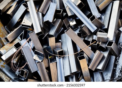 Metal scrap from the manufacturing process. Pile of steel waste prepared for recycling. - Shutterstock ID 2156332597