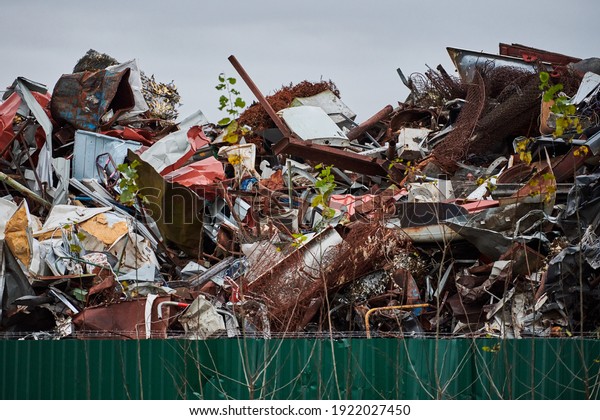 Metal scrap waste dump for recycling. City\
fenced landfill. Iron garbage and\
trash.