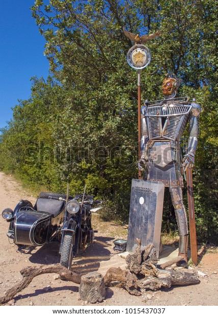 Metal sculpture of Roman legionary\
made of details of old cars & old bike with side car.\
